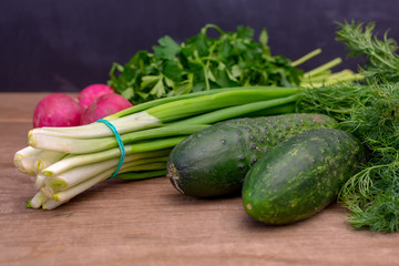 Onions, Cucumber and Radishes on wooden table