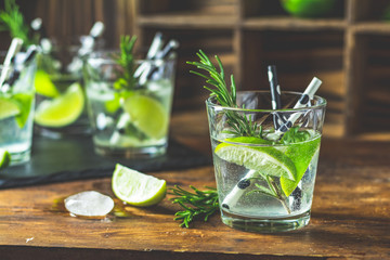 Fresh cocktail with lime, ice and rosemary