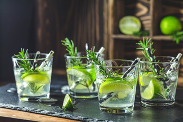 Fresh cocktail with lime, ice and rosemary