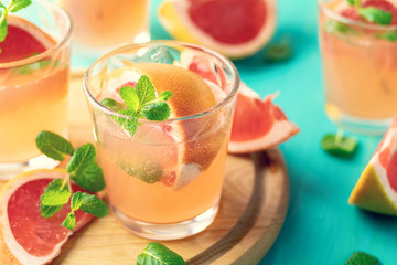 Pink alcoholic cocktail with grapefruit, ice and min