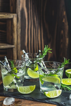 Fresh cocktail with lime, ice and rosemary