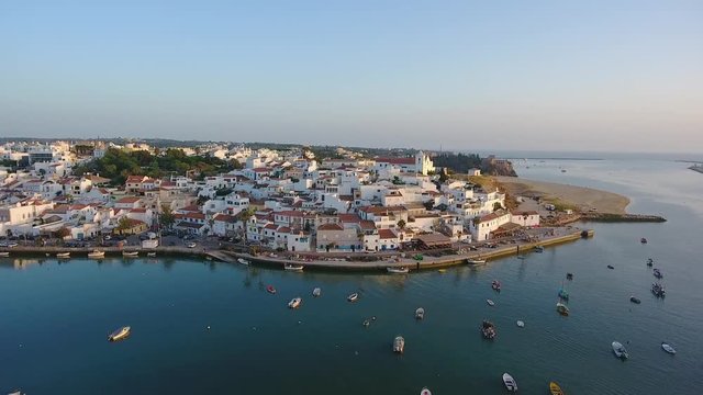 Aerial. Shooting from sky of Portuguese tourist city Ferragudo, view of the dock and beaches.