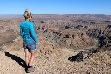 beautiful girl looks out over the Fish River Canyon - Namibia