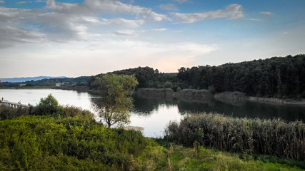 Fototapeta na wymiar Aerial view of lake surrounded by forest. Sumarice lake in Kragujevac - Serbia