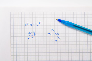 Top view of a notebook with a pitagoras statement. The concept of solving mathematical problems, problems with mathematics, counting learning.