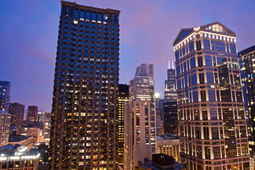 View of skyscrapers and buildings in downtown Chicago after sunset with amazing blue and pink sky
