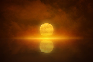 Yellow full moon rises in red glowing sky