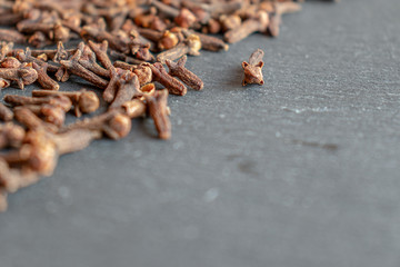 Spices/cloves on dark textured background