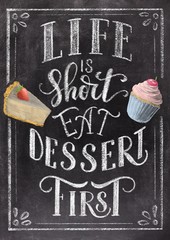 Hand lettering Life is short eat dessert first on retro black chalkboard background with sketch colorful cupcake and cheesecake sketch. Vintage illustration. © Ann Lou