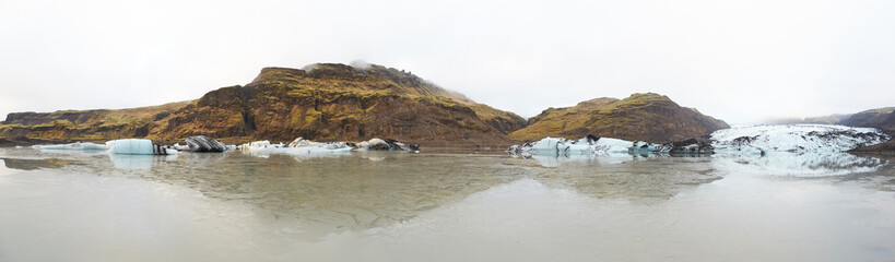 View on Skaftafell National Park, Iceland glacier ice tongues, rocks, moss, fog, clouds, cliffs, mountains
