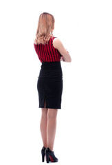Fototapeta premium Elegant woman in business black skirt leaves. Back view.