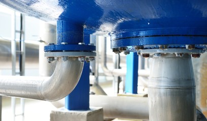 Large industrial water treatment and boiler room. Close-up of pressure vessel flanges