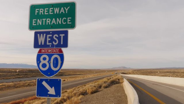 Interstate highway sign in a desert plane of Nevada.