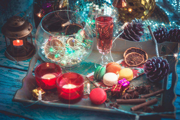 Christmas still life with glass of wine and macaroons