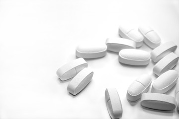 white medical pills, on white background, close-up