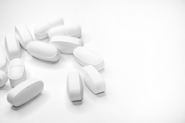 white medical pills, on white background, close-up