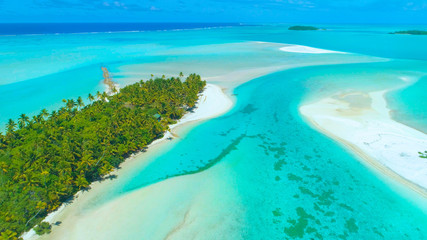 AERIAL: Flying above an idyllic exotic island in the middle of turquoise ocean.