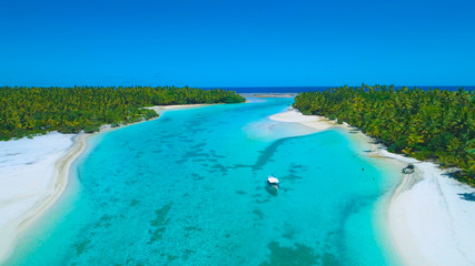 DRONE: Locals anchor their boat and jump into the refreshing turquoise water.
