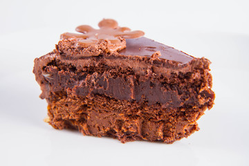 Chocolate cake - a slice on a plate on a white background