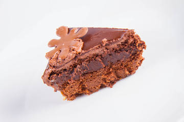 Chocolate cake - a slice on a plate on a white background