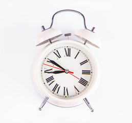 White retro alarm clock on a white background