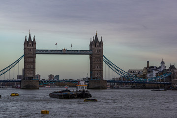Fototapeta na wymiar Landscape view of Tower bridge on the river Thames. Some ships sailing on the river. London, United Kingdom.