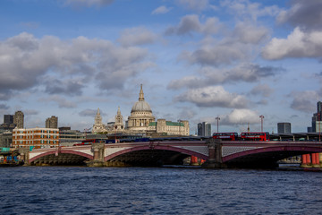 Fototapeta premium Landscape view of Southwark Bridge on the river Thames and business modern district with many skyscrapers in the background. London, United Kingdom.