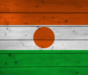 Flag of Niger on wooden background, surface. Wooden wall, planks. National flag