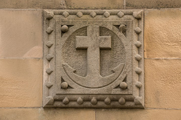 Old historical building with an anchor made of stone