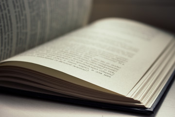 Fototapeta premium Open book isolated. Literature and education concept. Knowledge and wisdom background. Open pages with text. Library concept. Book storage. Open information. Read and study. Open book on table.