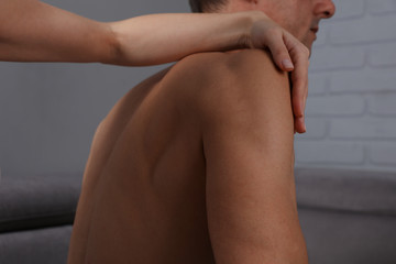 Man having Chiropractic or Osteopathy adjustment. Holistic care concept
