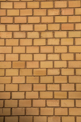 Old empty brick house factory wall with yellow bricks
