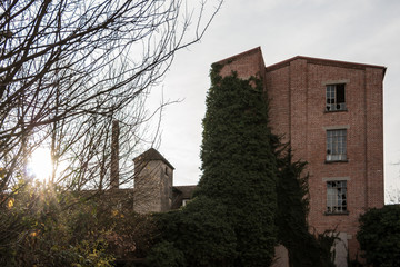 Old destroyed brick house ruin with broken windows