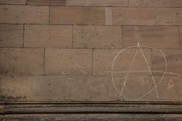 Old wall of a historical building with written anarchy sign