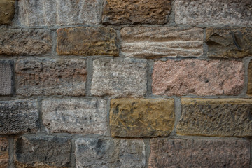 Old wall of a historical building with different colored stones