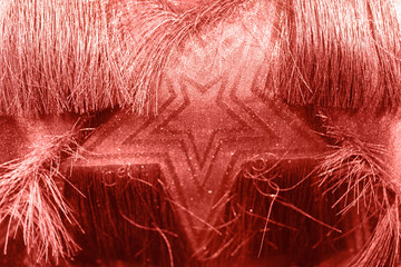 Beautiful festive coral background with metallic star shaped confetti. Holidays background. Place for text. Color of the year 2019. Living coral.