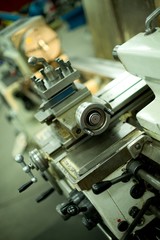 Lathe machine for metal cutting, machinery center background.
