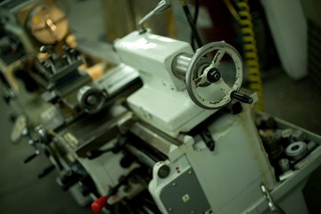 Lathe machine for metal cutting, machinery center background.