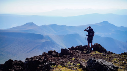Hiking man overlooking mountains