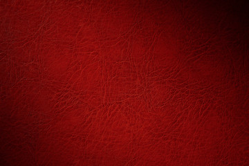 texture of red natural leather closeup with dimming