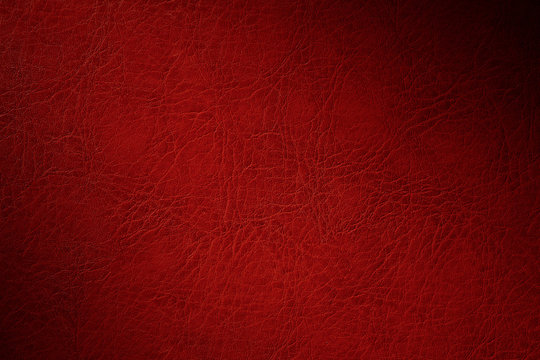 texture of red natural leather closeup with dimming