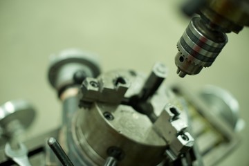 Lathe machine for metal cutting, machinery center background.