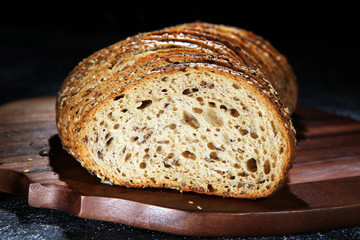 freshly baked bread on wooden board. cutted bread