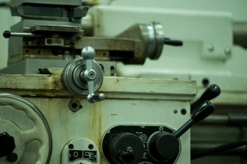 Lathe machine for metal cutting, machinery center background.