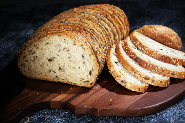 freshly baked bread on wooden board. cutted bread