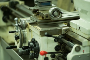 Lathe machine for metal cutting, machinery center background.