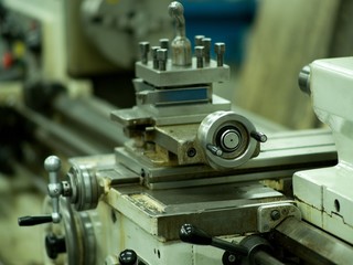 Lathe machine for metal cutting, machinery center background.