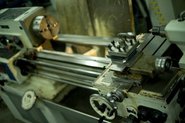 Lathe machine for metal cutting, machinery center background.