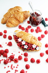 Delicious breakfast with fresh croissants and ripe berries
