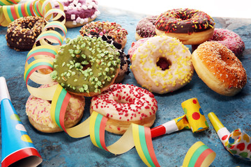 assorted donuts with chocolate frosted, pink glazed and sprinkles donuts